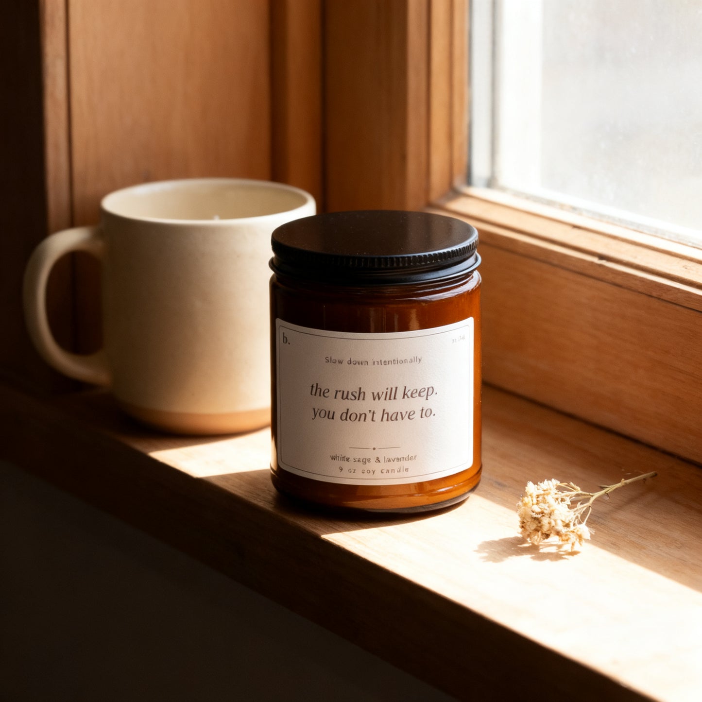 b.slow white sage and lavender candle on a sunlit windowsill with a ceramic mug and dried flowers